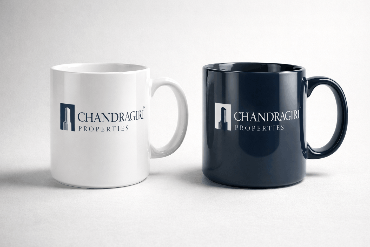 Navy and white Chandragiri-branded ceramic mugs from the engagement gift kit